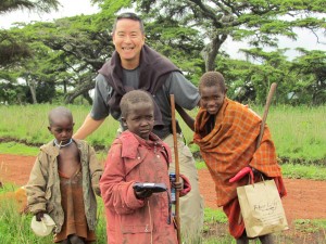 Rod Kuratomi with local children in the countryside near Negrogoro Crater. Photo courtesy of Rod Kuratomi