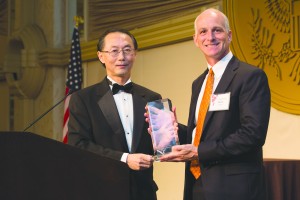 David Lin (left) presents Congressman Adam Smith with his Award. Photo by Joe Shymanski 