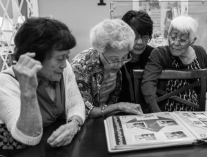 Aya Fujii and friends look at Aya's family scrapbook at Four Rivers Cultural Center, Ontario, Oregon. Photo by Rich Iwasaki