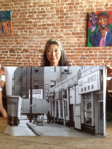 Nancy Sekizawa holding the image of The Atomic Café last located at First and Alameda in Los Angeles' Little Tokyo. Photo by Tadashi Nakamura 