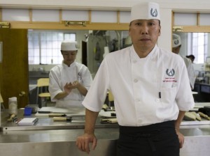 Chef Andy Matsuda stands inside the Sushi Chef Institute kitchen. 